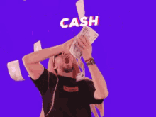 a man is throwing money in the air and the word cash is behind him