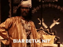 a man in a costume with the words biar betul ni on the bottom