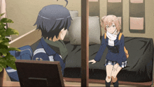 a girl sitting on a bed talking to a boy