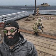 a man with a beard wears sunglasses and a hat that says ' coca cola ' on it