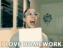 a woman wearing glasses is holding a piece of paper over her face and says i love homework