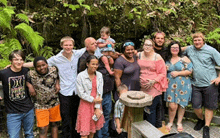 a group of people posing for a picture including one wearing a shirt that says hurley