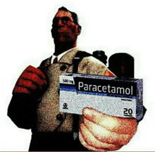 a man holds a box of paracetamol in his hand