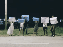 a group of people holding up signs that say kenneth matther