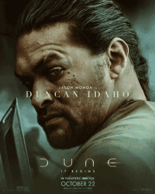 a movie poster for dune shows a man holding a knife