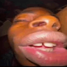 a close up of a person 's face with their eyes closed and a huge mouth .