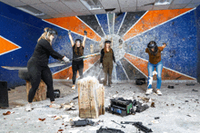 three women are playing a game of axe throwing in a room