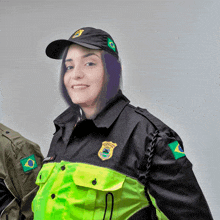 a woman wearing a black and yellow uniform with a badge that says policia militar