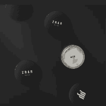 a group of zrar design buttons are laying on a black surface