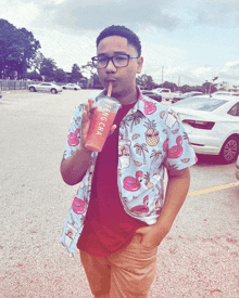 a young man drinking from a cup that says feng cha