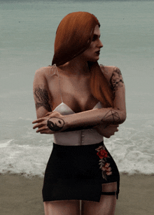 a woman with a tattoo on her arm has her arms crossed on the beach