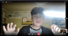 a man wearing glasses is on a video call with a skype logo on the screen