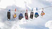 face masks hanging on a clothes line against a blue sky