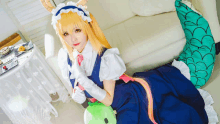 a woman in a maid costume is laying on the floor