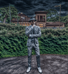 a man in a suit and hat is standing in front of a building with a street sign that says ' emerald hill '