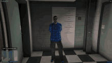 a man in a blue plaid shirt and black pants is standing in front of a wall with a picture of him on it