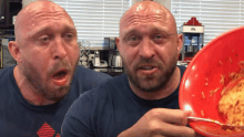 a bald man with a beard is holding a bowl of food