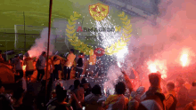 a group of people are holding flares in front of a sign that says armacedo