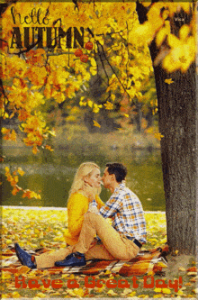 a picture of a man and woman kissing under a tree with the words hello autumn have a great day