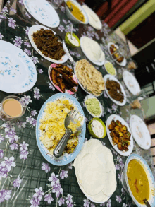 a table topped with plates of food including rice