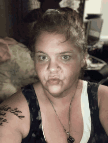 a woman with a tattoo on her shoulder that says " i love you "