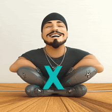 a man with a beard is sitting on a wooden table with a blue letter x