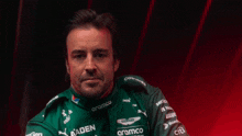 a man wearing a green shirt with the name fernando alonso on the bottom