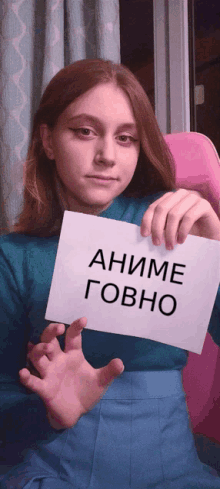 a girl in a blue shirt holds up a sign that says anime govo