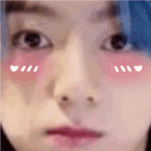 a close up of a person 's face with hearts on their cheeks