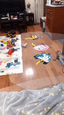 a living room with a lot of toys on the floor including a robocar poli sticker