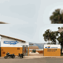 a motorcycle parked in front of a building that says imediato gas e agua