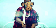 a man in a plaid shirt is holding a sword with a monkey face on his face .