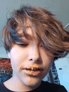 a close up of a person with peanut butter on their face