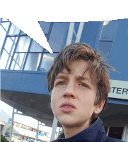 a young boy stands in front of a building with the word ter on it