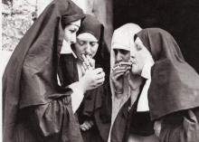 a group of nuns are smoking cigarettes together in a black and white photo