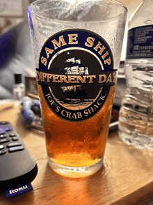 a glass that says " same ship different day joe 's crab shack "