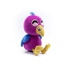 a purple stuffed bird with a yellow beak and blue wings