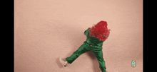 a woman with red hair and green pants is dancing