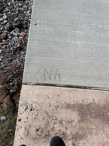 the word cna is written on the sidewalk