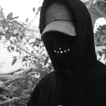 a person wearing a black hoodie with mxdvs on it