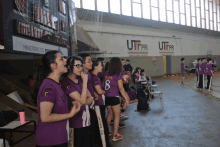 a group of people wearing purple shirts that say utpr