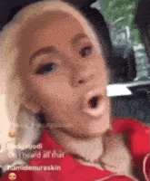 a woman is sitting in a car with her mouth open