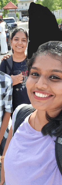 a woman in a purple shirt smiles for a photo