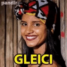 a woman wearing a head scarf is smiling and the word gleici is on her face .