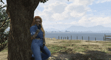 a woman leaning against a tree in a video game with mountains in the background