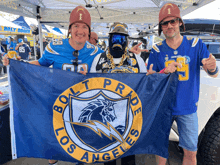 three men are holding a los angeles flag