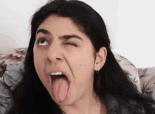 a woman making a funny face with her tongue sticking out