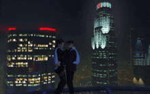 a couple standing on a rooftop with a building in the background that says ' chase ' on it