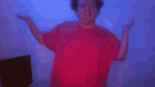 a blurry picture of a person in a red shirt against a blue wall