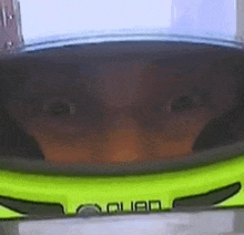 a close up of a person wearing a helmet with their eyes visible .